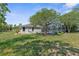 Spacious backyard featuring a screened-in pool and lush greenery at 14031 Hexam Rd, Brooksville, FL 34613