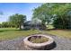 Home showing an in-ground pool, large screened in enclosure, lush landscaping, and fire pit at 14031 Hexam Rd, Brooksville, FL 34613