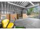 Barn interior with stalls, an open doorway, and exterior views at 14031 Hexam Rd, Brooksville, FL 34613