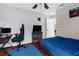 Comfortable bedroom featuring a modern ceiling fan, desk, and blue accents at 14031 Hexam Rd, Brooksville, FL 34613