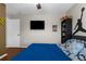 This bedroom features a playful Michael Jordan wall decal, ceiling fan, and a mounted flat-screen television at 14031 Hexam Rd, Brooksville, FL 34613