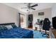 The bedroom boasts a vibrant blue bedspread and a comfortable workstation with an ergonomic gaming chair at 14031 Hexam Rd, Brooksville, FL 34613