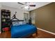 Spacious bedroom is accented by a vibrant blue bedspread and a playful Michael Jordan silhouette wall decal at 14031 Hexam Rd, Brooksville, FL 34613