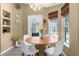 Bright dining area with a round table, four chairs, and natural light at 14031 Hexam Rd, Brooksville, FL 34613