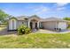 A charming home featuring a well-manicured lawn and attached two car garage at 14031 Hexam Rd, Brooksville, FL 34613