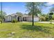 Attractive home with a long driveway, attached garage, and well-maintained lawn at 14031 Hexam Rd, Brooksville, FL 34613