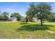 Lovely home showing large metal outbuilding, well manicured lawn, and a tree swing at 14031 Hexam Rd, Brooksville, FL 34613