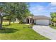 Charming home with two-car garage, landscaped yard, and mature trees at 14031 Hexam Rd, Brooksville, FL 34613