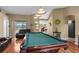 Well-lit game room with a pool table and comfortable seating, perfect for recreation at 14031 Hexam Rd, Brooksville, FL 34613