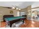 Inviting game room boasts a full-sized pool table, comfortable seating, and sliding glass doors offering a view of the pool and patio at 14031 Hexam Rd, Brooksville, FL 34613