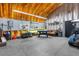 Large garage area featuring a golf cart, recreational games, storage, and ample space at 14031 Hexam Rd, Brooksville, FL 34613