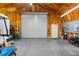 Spacious garage with roll-up door, insulated ceiling, and side door for easy access at 14031 Hexam Rd, Brooksville, FL 34613