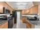 Efficient kitchen with stainless steel appliances, granite countertops, and ample cabinet space at 14031 Hexam Rd, Brooksville, FL 34613