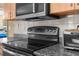 Close-up of a well-equipped kitchen with a modern range and sleek design elements at 14031 Hexam Rd, Brooksville, FL 34613