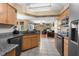 Bright kitchen with a view of the living room, modern appliances, and stone counters at 14031 Hexam Rd, Brooksville, FL 34613