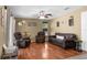 Comfortable living room features hardwood floors, neutral walls, and a ceiling fan at 14031 Hexam Rd, Brooksville, FL 34613