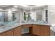 The main bathroom has a granite countertop with dual glass bowl sinks and a mirror wall with recessed lighting at 14031 Hexam Rd, Brooksville, FL 34613