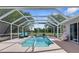 Gorgeous screened-in pool with ample seating and a serene backyard view at 14031 Hexam Rd, Brooksville, FL 34613