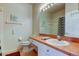 Well-lit bathroom featuring a white vanity and tiled floors at 14466 Tamarind Loop, Spring Hill, FL 34609
