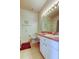 Clean bathroom with white vanity, modern lighting, and tiled floors at 14466 Tamarind Loop, Spring Hill, FL 34609