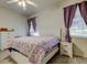 Cozy bedroom with matching furniture, ceiling fan, and natural light at 14466 Tamarind Loop, Spring Hill, FL 34609