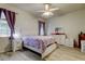 Well-lit bedroom with a ceiling fan, light wood floors, and white furniture at 14466 Tamarind Loop, Spring Hill, FL 34609