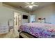 Bedroom featuring ensuite access, mounted television, and light wood floors at 14466 Tamarind Loop, Spring Hill, FL 34609