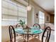 Dining area illuminated by natural light with a contemporary chandelier at 14466 Tamarind Loop, Spring Hill, FL 34609