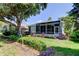 Rear of the home shows the screened-in lanai and lush landscaping at 14466 Tamarind Loop, Spring Hill, FL 34609