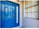 Bright blue front door with window, providing a welcoming entry at 14466 Tamarind Loop, Spring Hill, FL 34609