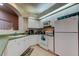 Bright kitchen featuring white cabinetry, appliances, and tile flooring at 14466 Tamarind Loop, Spring Hill, FL 34609