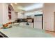 Bright kitchen featuring neutral cabinets and countertops with a breakfast bar at 14466 Tamarind Loop, Spring Hill, FL 34609