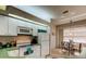 Well-lit kitchen with white appliances, green countertops, and a breakfast nook at 14466 Tamarind Loop, Spring Hill, FL 34609