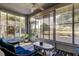 Bright sun room with wicker furniture and lots of windows at 14466 Tamarind Loop, Spring Hill, FL 34609