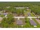 An aerial view of the property shows the layout of the neighborhood with green tree coverage at 15414 Green Jay Rd, Weeki Wachee, FL 34614