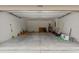 A large garage for parking and storage with overhead lighting and high ceilings at 15414 Green Jay Rd, Weeki Wachee, FL 34614