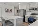 Modern kitchen with gray cabinets, stainless steel appliances, island with seating, and open layout at 15414 Green Jay Rd, Weeki Wachee, FL 34614