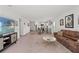 Open living room with modern gray kitchen and stainless steel appliances at 15414 Green Jay Rd, Weeki Wachee, FL 34614