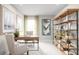 Home office features a wooden desk, modern chair, stylish bookcase, and decor at 1699 W Palms Dr, Port Charlotte, FL 33953