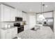 Bright kitchen featuring white cabinets, stainless steel appliances, granite countertops, and a stylish island at 1699 W Palms Dr, Port Charlotte, FL 33953