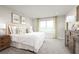 Serene main bedroom with plush bedding, soft lighting, neutral decor, and a view of the landscape at 1699 W Palms Dr, Port Charlotte, FL 33953
