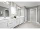 This bathroom features dual sinks, white cabinetry, and a walk-in shower at 1705 W Palms Dr, Port Charlotte, FL 33953