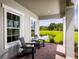 Cozy front porch with two chairs and a view of a pond at 1705 W Palms Dr, Port Charlotte, FL 33953