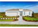 Charming single-story home boasts a manicured lawn and inviting blue front door at 1723 W Palms Dr, Port Charlotte, FL 33953