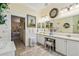 Bright bathroom featuring double vanity, ample counter space, and a view towards the bedroom at 18223 Nestlebranch Ct, Hudson, FL 34667