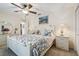 Bright bedroom with a large bed, soft lighting, and a closet with a view of the ensuite bathroom at 18223 Nestlebranch Ct, Hudson, FL 34667