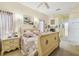 Cozy bedroom with neutral tones, comfortable bed, and a serene atmosphere with ensuite bathroom at 18223 Nestlebranch Ct, Hudson, FL 34667