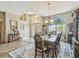 Spacious dining room featuring elegant decor, hardwood floors, and large windows at 18223 Nestlebranch Ct, Hudson, FL 34667