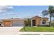 Charming single-story home with a well-manicured lawn, mature landscaping, and a welcoming entrance at 18223 Nestlebranch Ct, Hudson, FL 34667