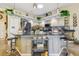 Stylish kitchen with gray cabinets, granite countertops, and modern stainless steel appliances at 18223 Nestlebranch Ct, Hudson, FL 34667